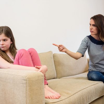 Daughter ignoring her mother after an argument in living room at home